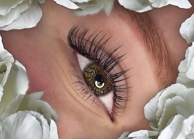 Close-up of elegant eyelash extension at Premier Beauty Clinic, Tallinn, Kesklinn, EE, surrounded by white petals.
