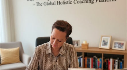 A woman writing in an office at Tranquil Success Academy, Stoke-on-Trent, England, GB.
