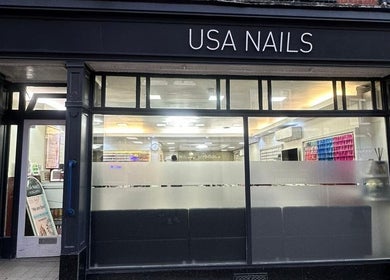 Front view of Usa Nails (Basingstoke), featuring modern glass facade in Basingstoke, England, GB.