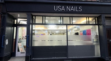 Front view of Usa Nails (Basingstoke), featuring modern glass facade in Basingstoke, England, GB.