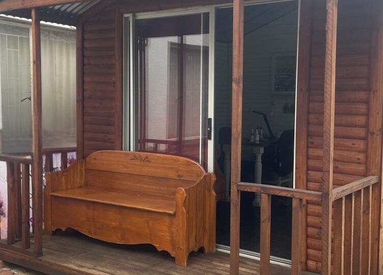 Charming wooden exterior of SassyNailsbyAnezane, Pretoria, Gauteng, ZA, featuring a rustic bench.