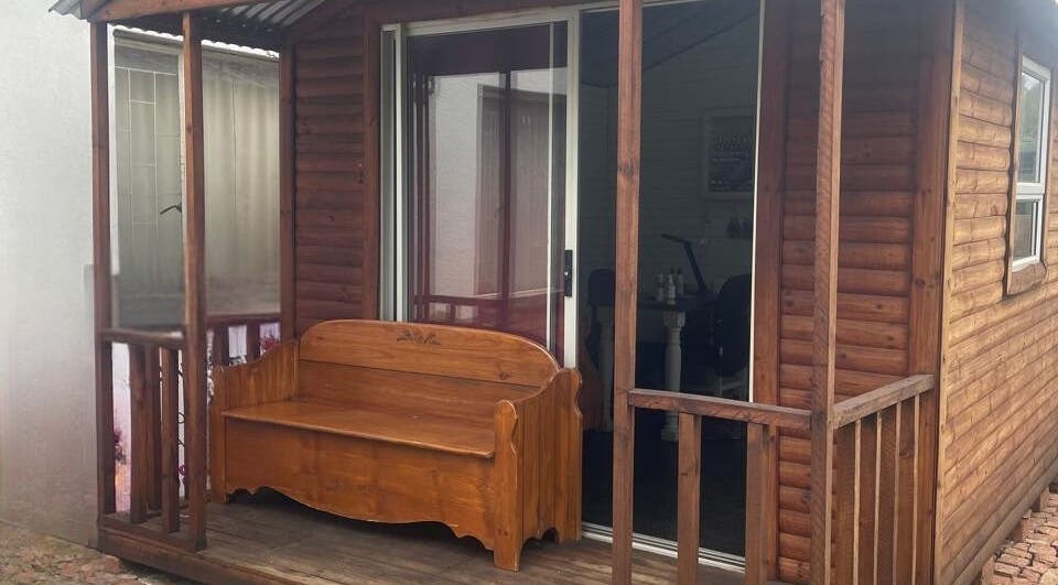 Charming wooden exterior of SassyNailsbyAnezane, Pretoria, Gauteng, ZA, featuring a rustic bench.