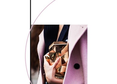Elegant golden clutch held by a woman in a pink coat at Nails Show, Huelva, Andalucía, ES.