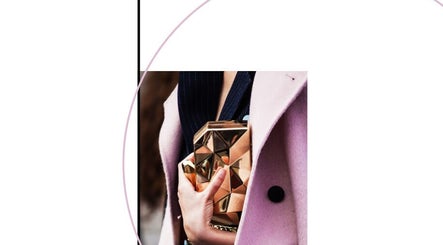 Elegant golden clutch held by a woman in a pink coat at Nails Show, Huelva, Andalucía, ES.