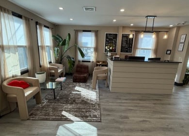 Inviting lobby at Brunetto Beauty, Oakland, New Jersey, US with beige decor and natural lighting.