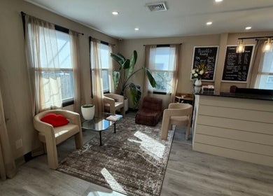 Relaxing lounge area at Brunetto Beauty, Oakland, New Jersey with plush seating and natural light.
