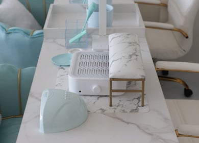 Chic nail station at Shadi Nails in Conoga Park, California, US, featuring a marble tabletop and plush seating.