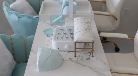 Chic nail station at Shadi Nails in Conoga Park, California, US, featuring a marble tabletop and plush seating.