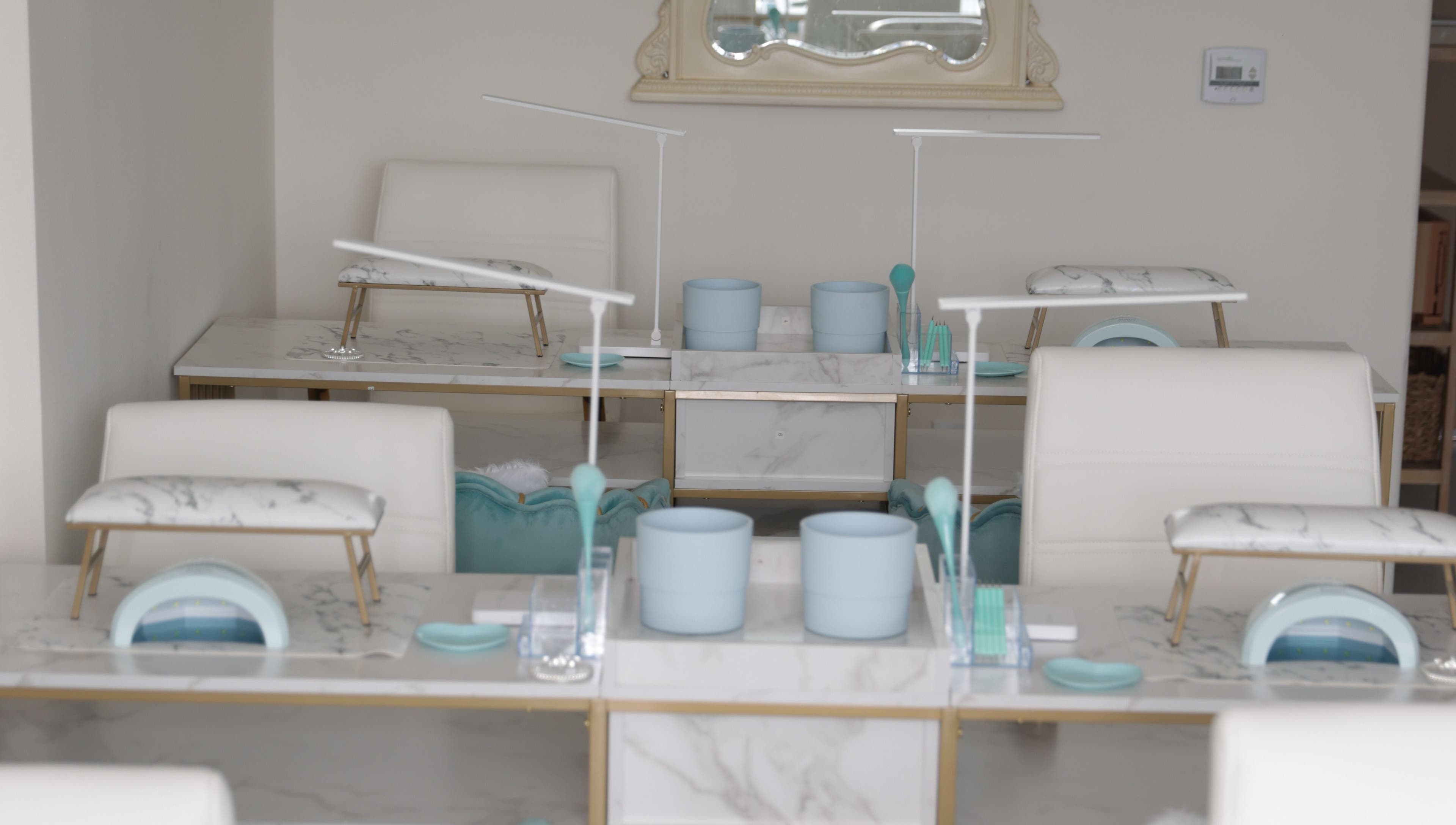 Luxurious nail stations at Shadi Nails, Conoga Park, California, US, featuring sleek marble surfaces.