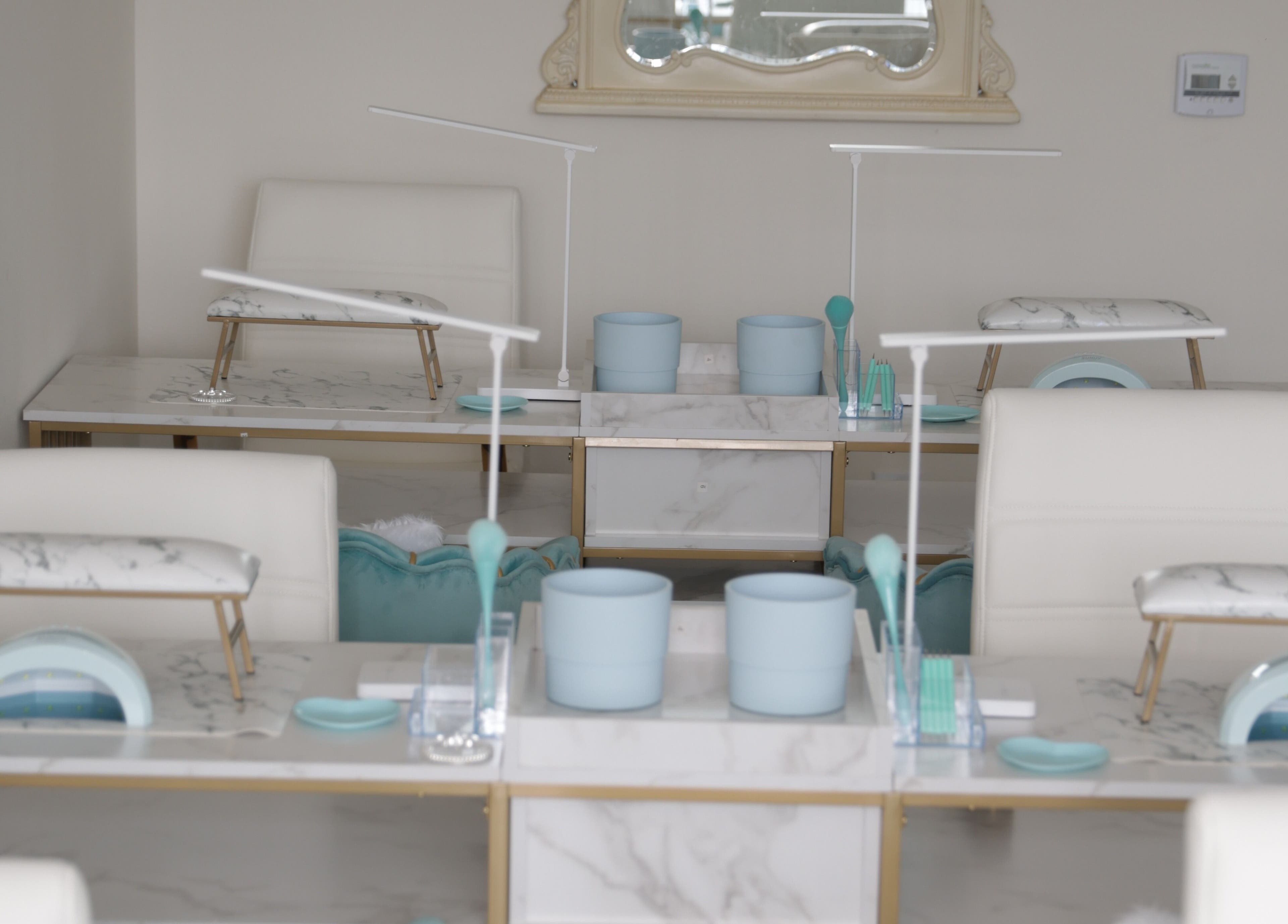 Luxurious nail stations at Shadi Nails, Conoga Park, California, US, featuring sleek marble surfaces.