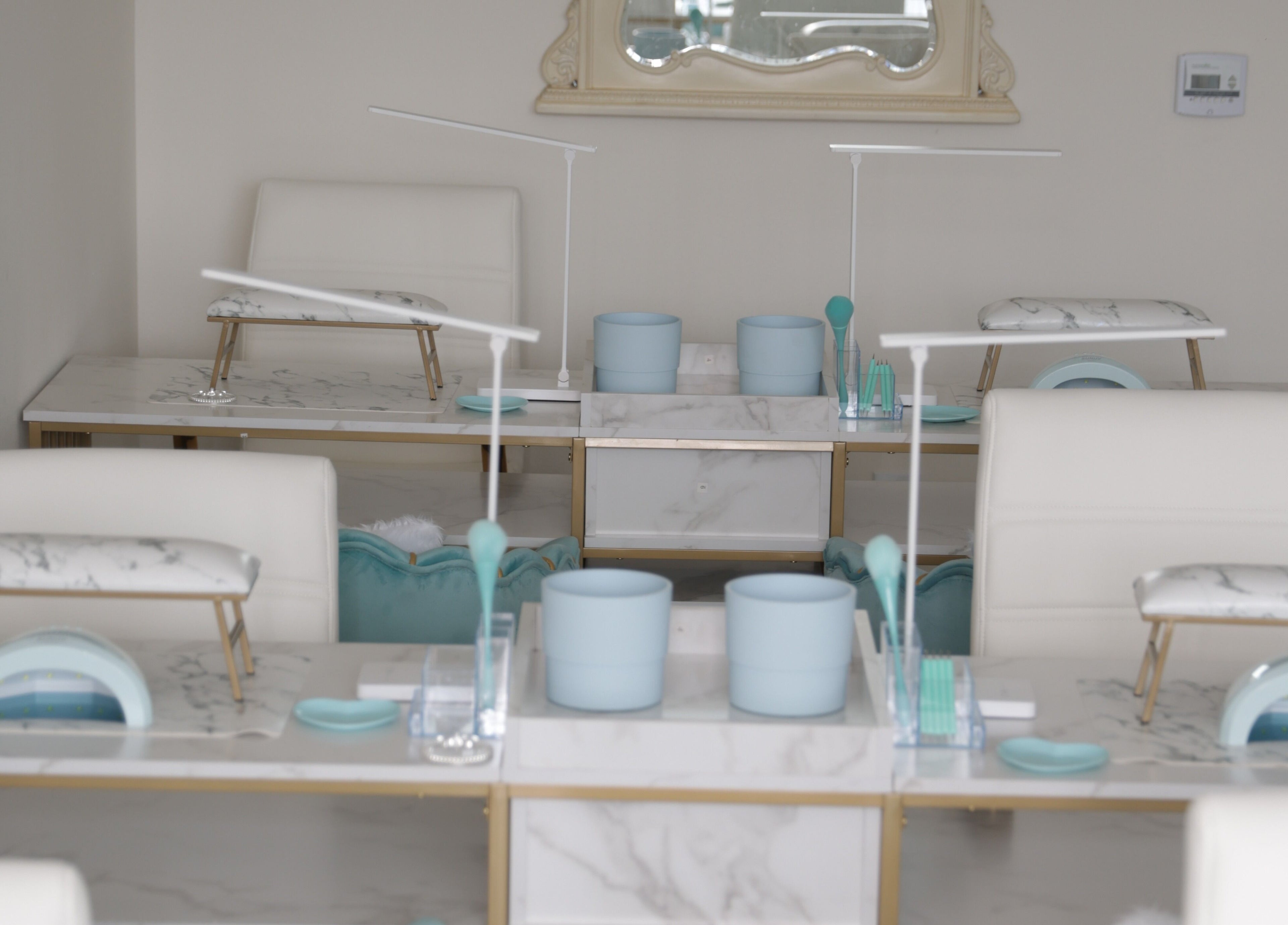 Luxurious nail stations at Shadi Nails, Conoga Park, California, US, featuring sleek marble surfaces.