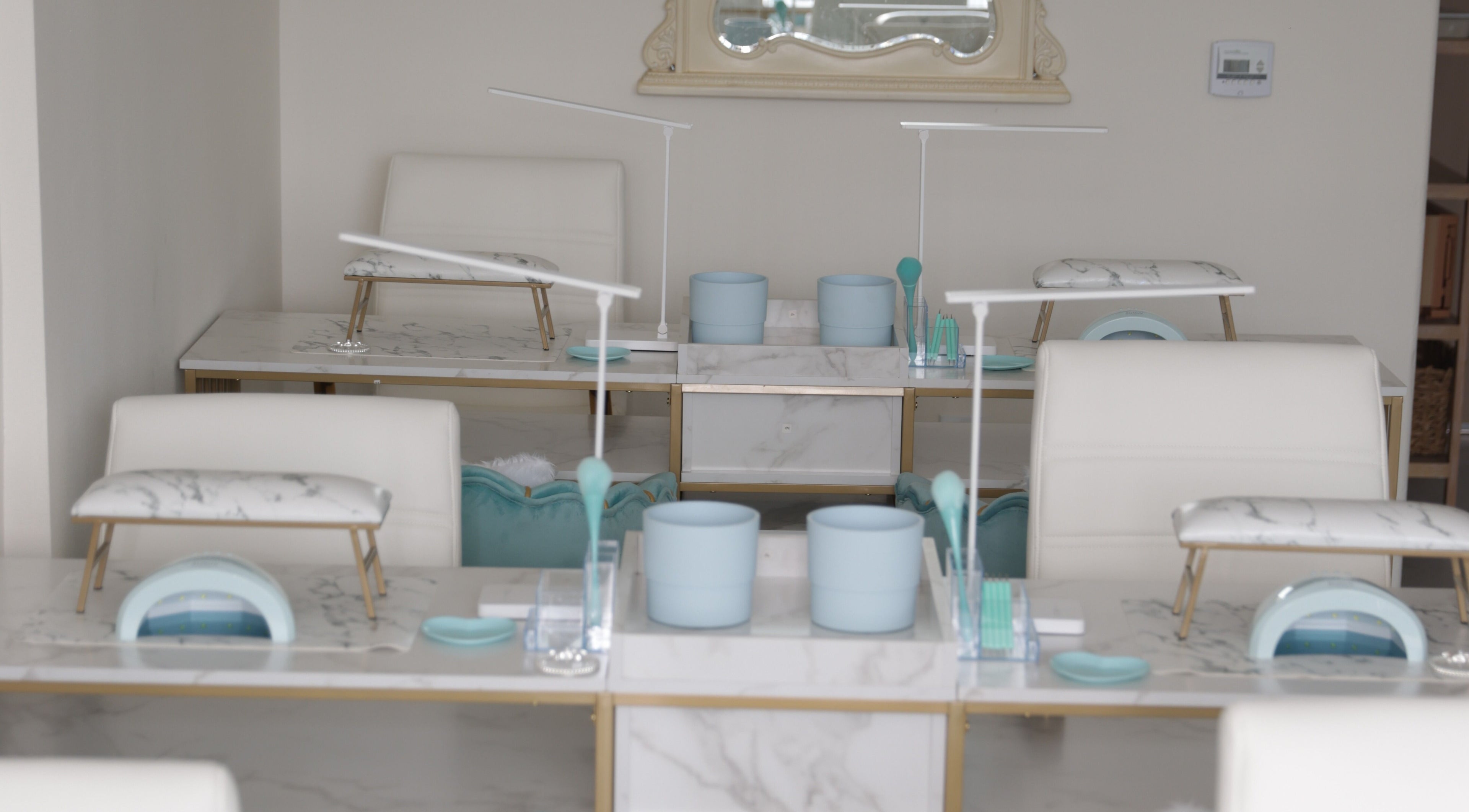 Luxurious nail stations at Shadi Nails, Conoga Park, California, US, featuring sleek marble surfaces.