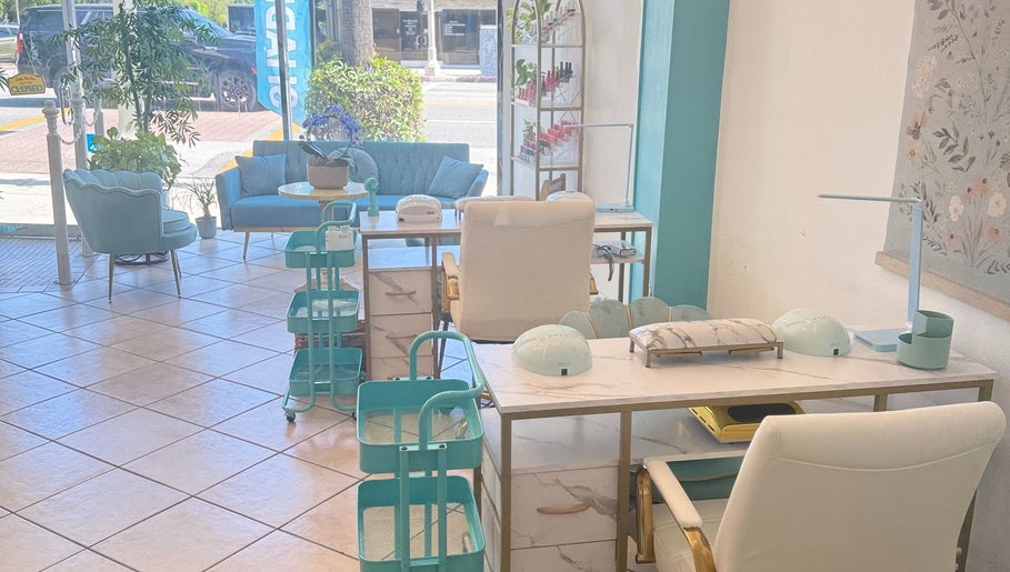 Cozy nail salon interior at Shadi Nails in Encino, California, US, featuring pastel seating and modern decor.