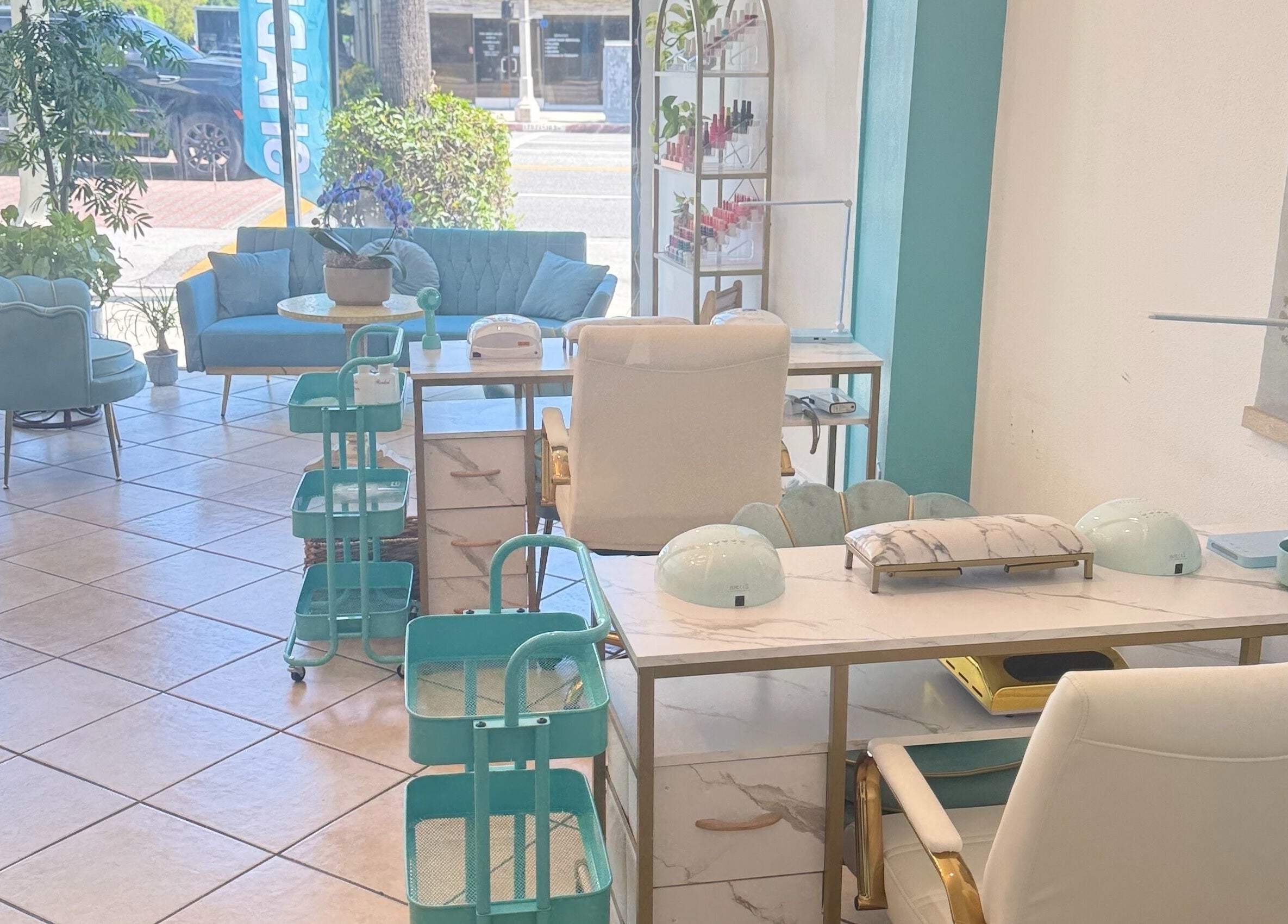 Cozy nail salon interior at Shadi Nails in Encino, California, US, featuring pastel seating and modern decor.