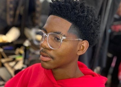 Client with trendy haircut and glasses at Friendly Salon, Soshanguve, Gauteng, ZA.