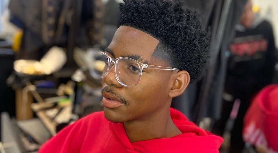 Client with trendy haircut and glasses at Friendly Salon, Soshanguve, Gauteng, ZA.