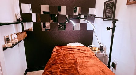 Inviting treatment room at Noire Naturels Aesthetics in Dallas, Texas, US with plush decor and ambient lighting.