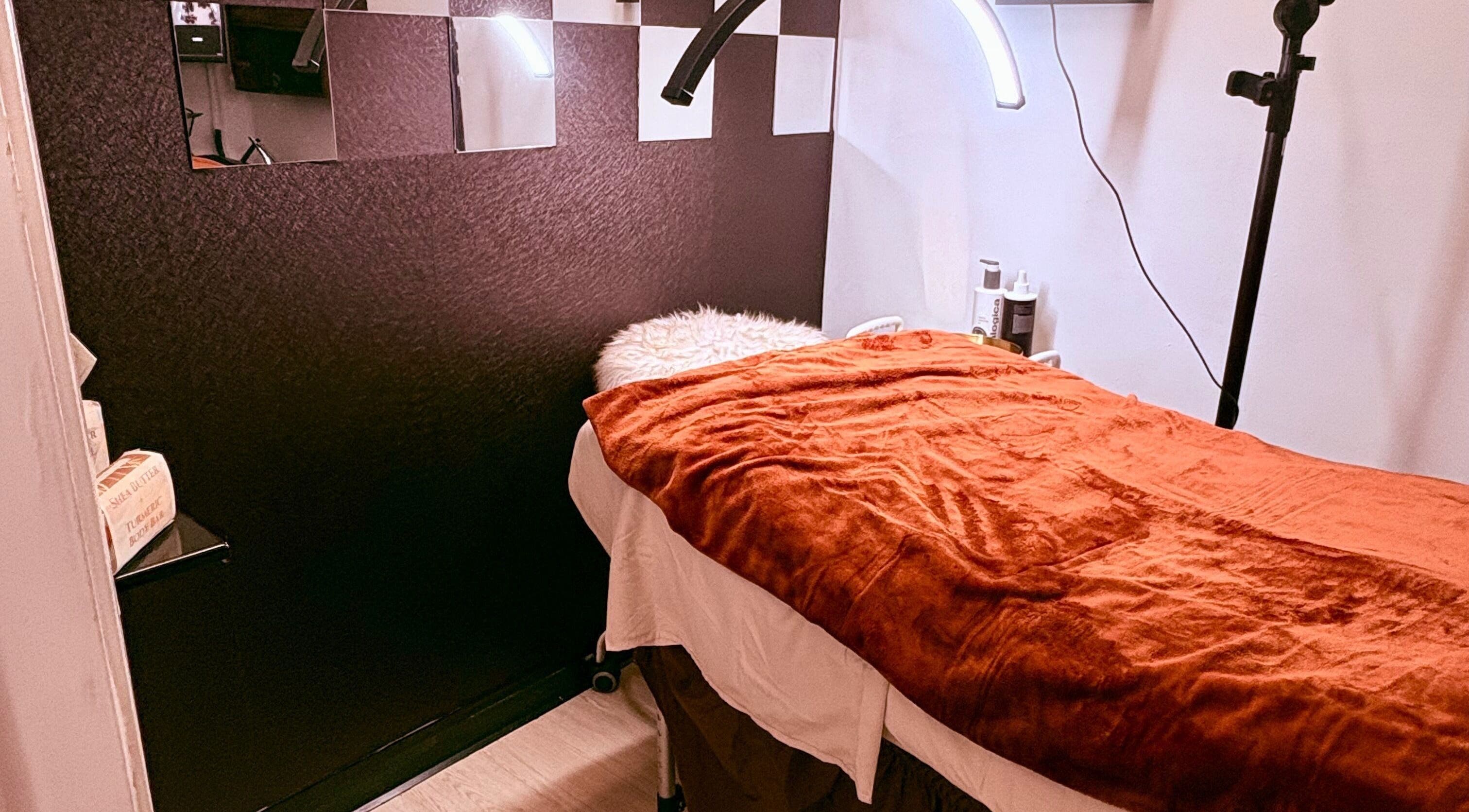 Luxury treatment room at Noire Naturels Aesthetics, Dallas, Texas, US with a cozy bed and ambient lighting.