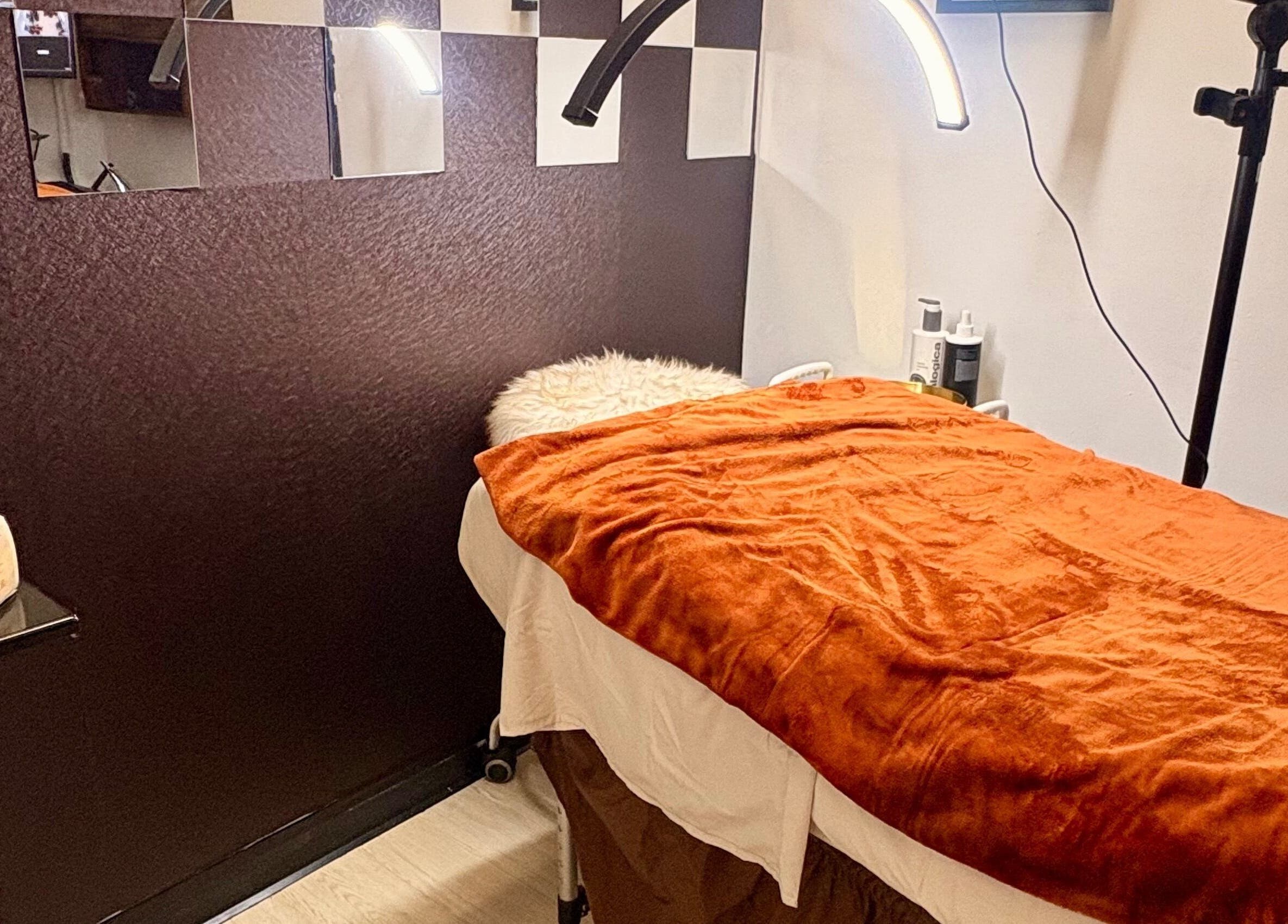 Cozy treatment room at Noire Naturels Aesthetics, Dallas, Texas, US, with plush decor and warm lighting.