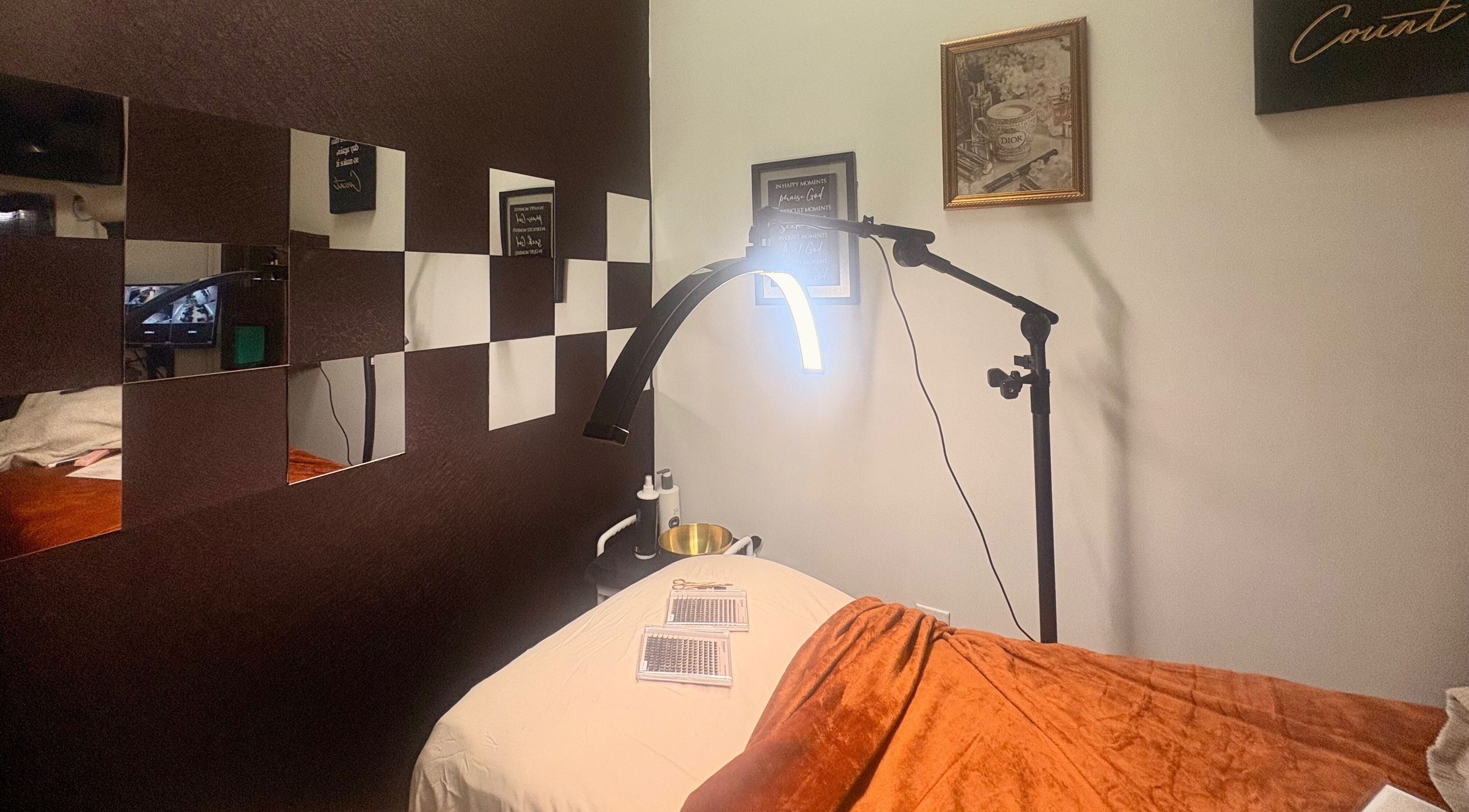 Cozy treatment room at Noire Naturels Aesthetics, Dallas, Texas, US, featuring ambient lighting and soft decor.