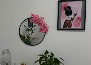 Chic decor with mirror, plant, and vibrant artwork at Exotic Lash and Brow Studio, Durban, Kwazulu-natal, ZA.
