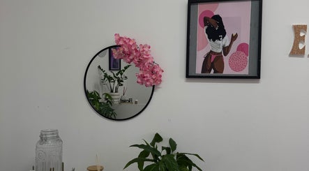 Chic decor with mirror, plant, and vibrant artwork at Exotic Lash and Brow Studio, Durban, Kwazulu-natal, ZA.