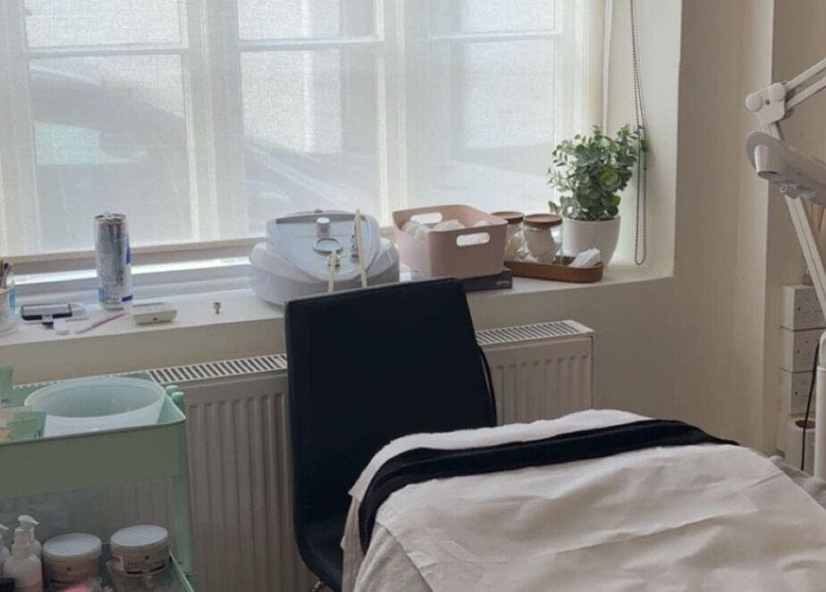 Cozy skincare room at Glow Up With Molly in Wheathampstead, England, GB, featuring treatment bed and skincare products.