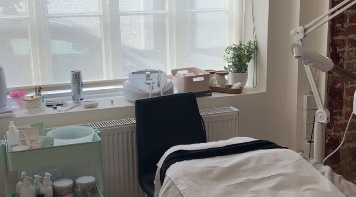 Cozy skincare room at Glow Up With Molly in Wheathampstead, England, GB, featuring treatment bed and skincare products.
