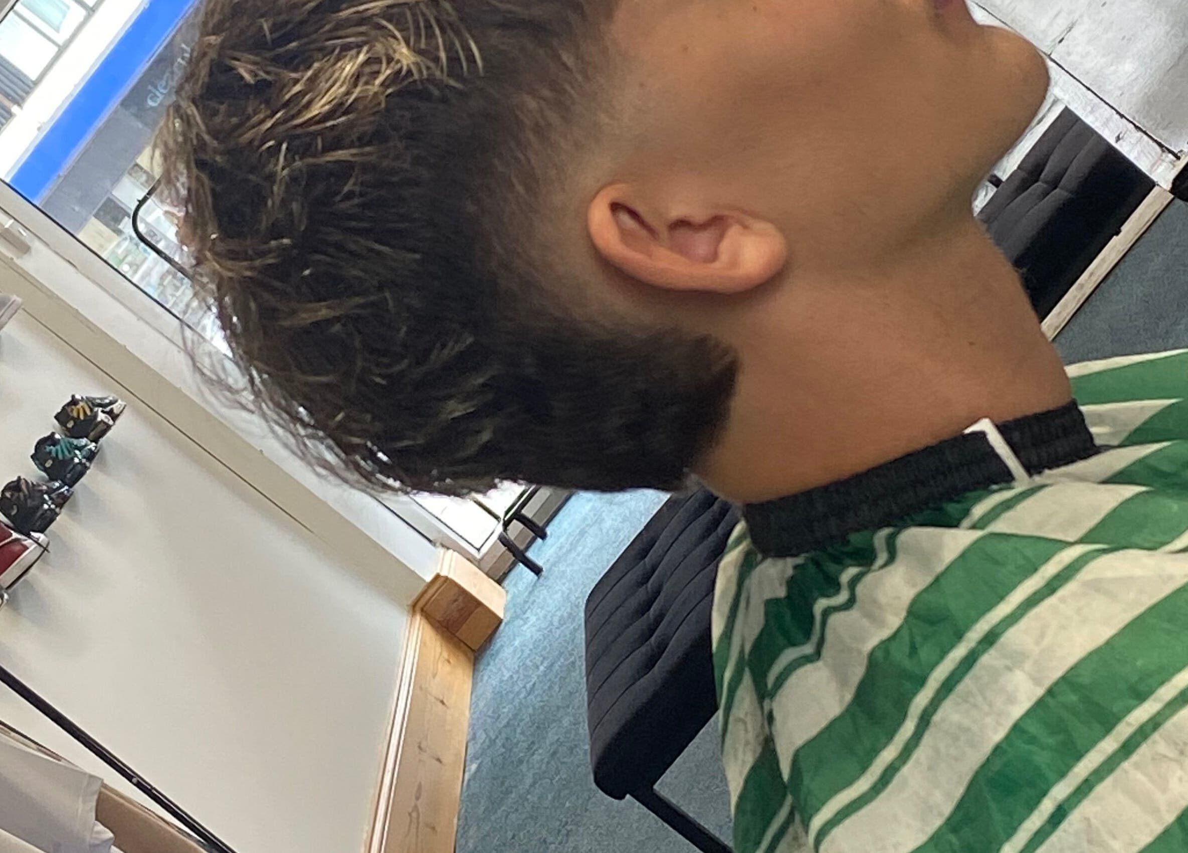 Close-up of a fresh haircut at crainerscutz, Ramsey, Ramsey, IM. Modern style in a chic venue.