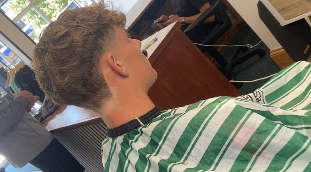 Back view of a haircut at crainerscutz in Ramsey, Ramsey, IM. Trendy and modern hairstyle showcased.