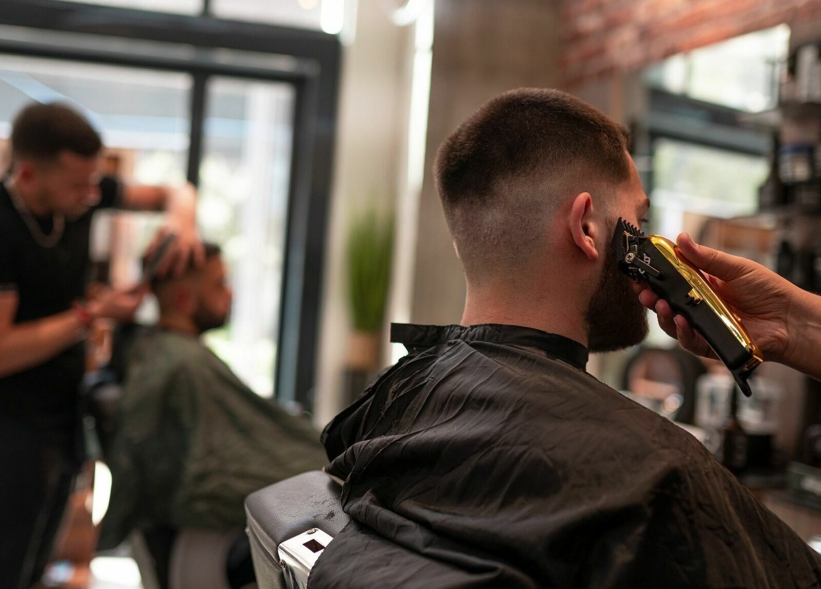 Expert barber at Studio 44 On Madison in Gibraltar, GI providing a detailed haircut for a client.