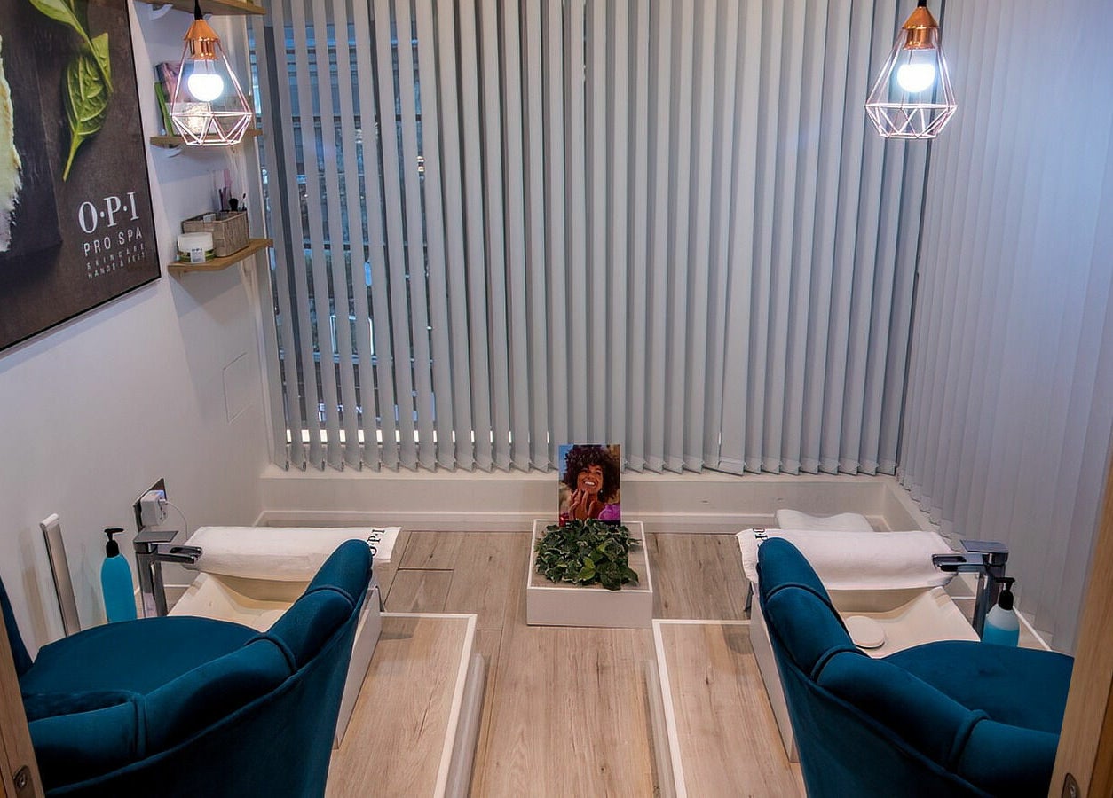 Elegant pedicure station at Studio 44 On Madison, Gibraltar, GI with plush chairs and modern decor.