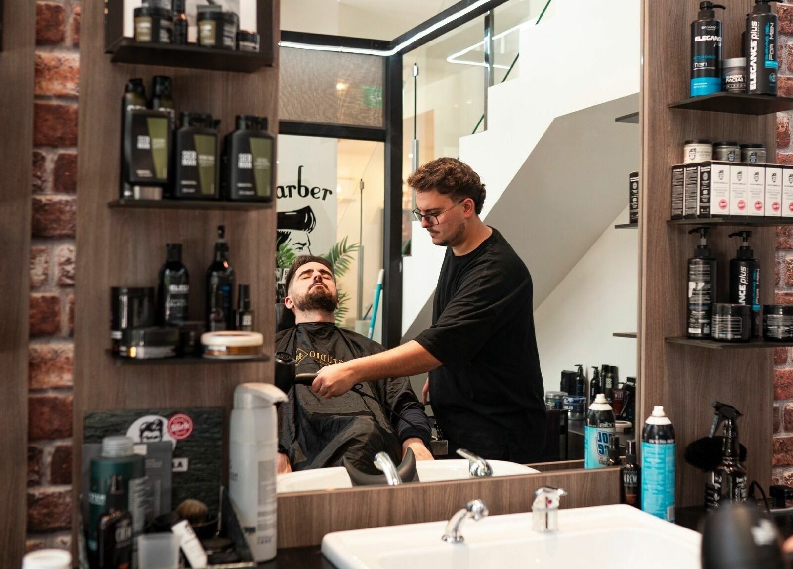 Barber styling at Studio 44 On Madison, Gibraltar. Elegant setup with premium products in view.