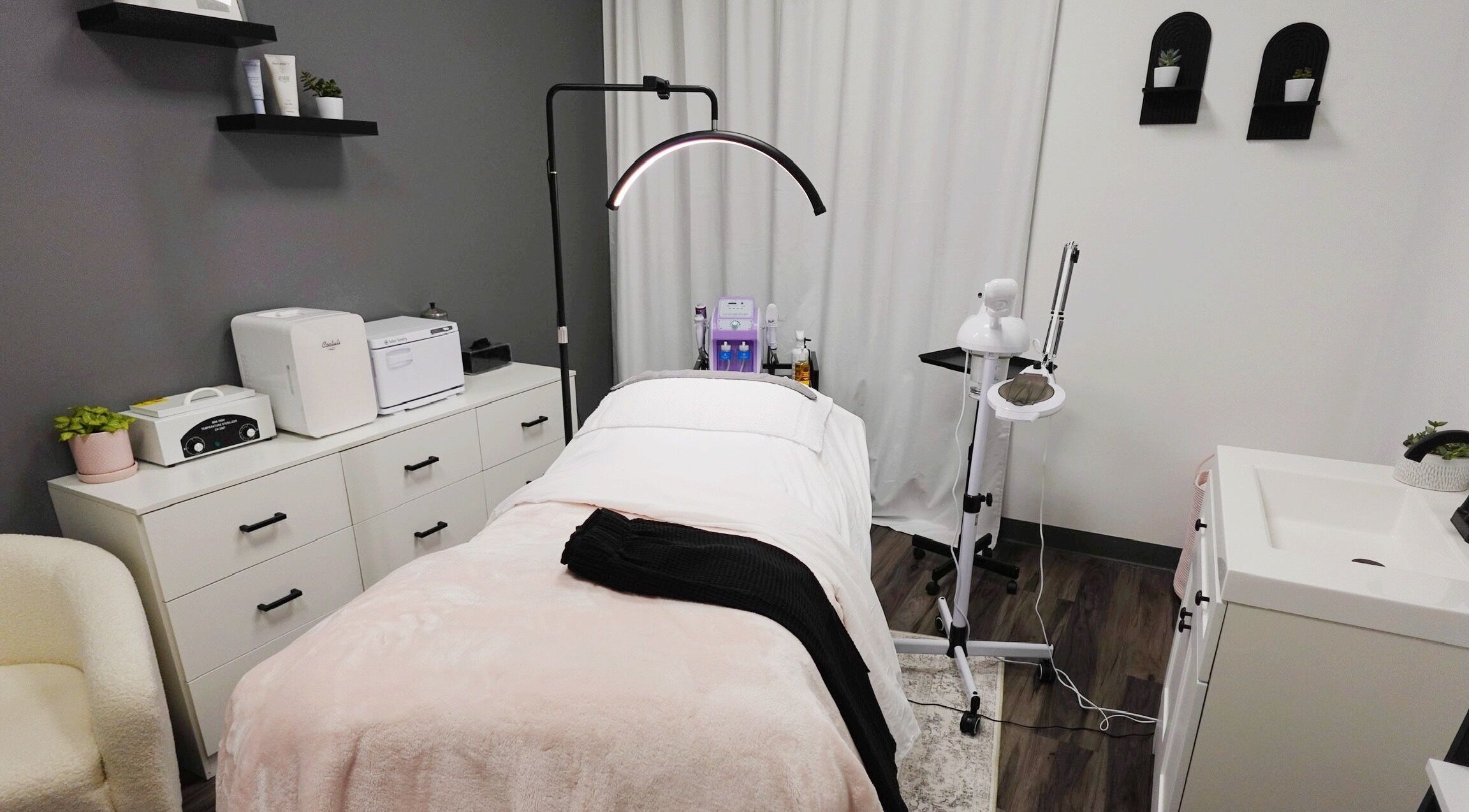 Relaxing treatment room at Revive Skin Studio, San Jose, California, US, featuring modern spa equipment.