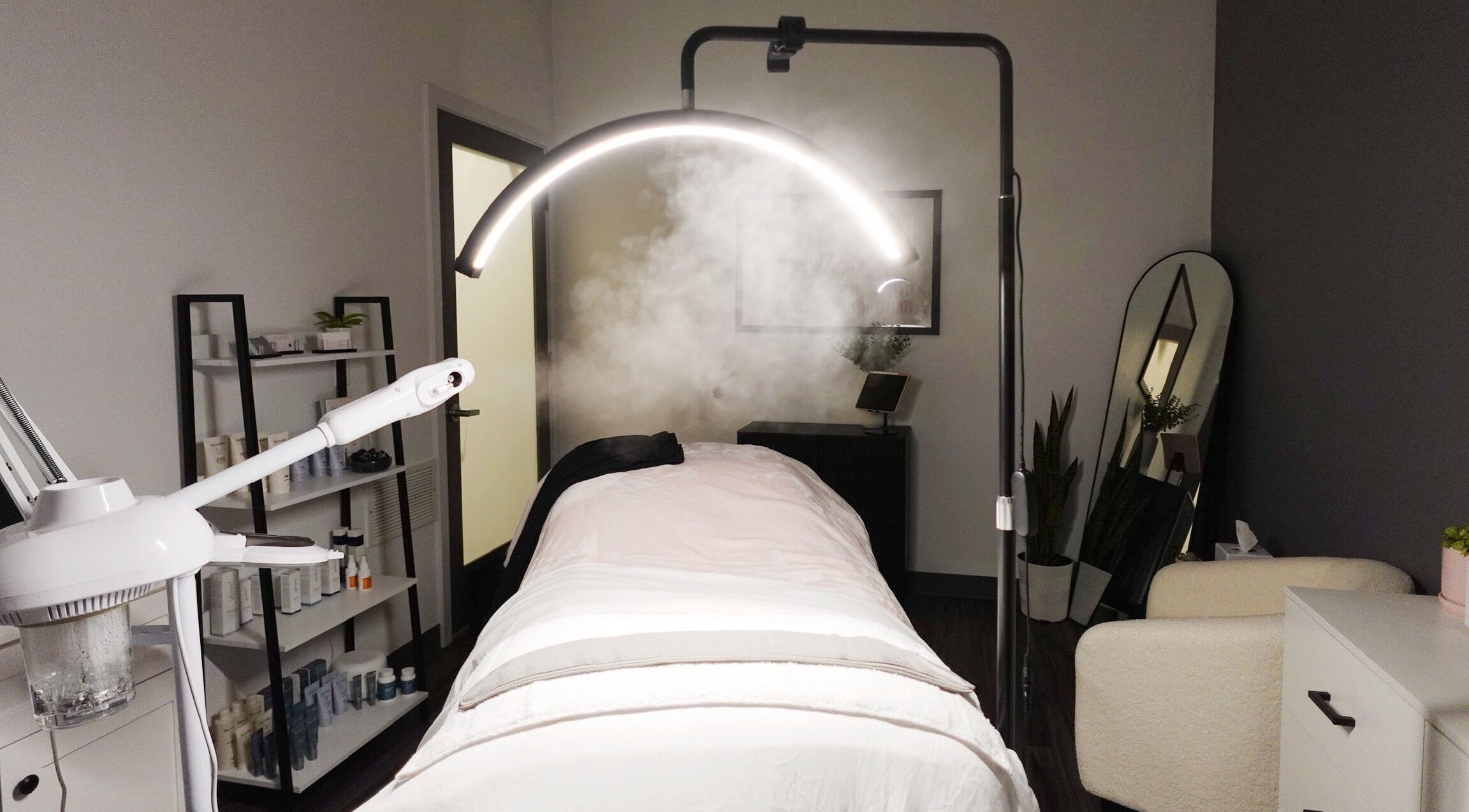 Tranquil treatment room at Revive Skin Studio, San Jose, California, US, featuring cozy bed and soothing decor.