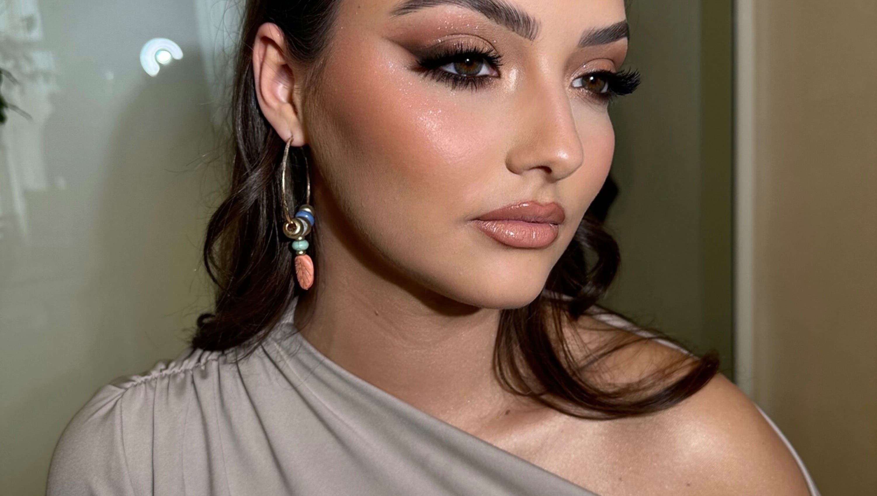 Close-up of elegant makeup at Aria Beauty in Enfield, England, GB, showcasing subtle glam and chic earrings.