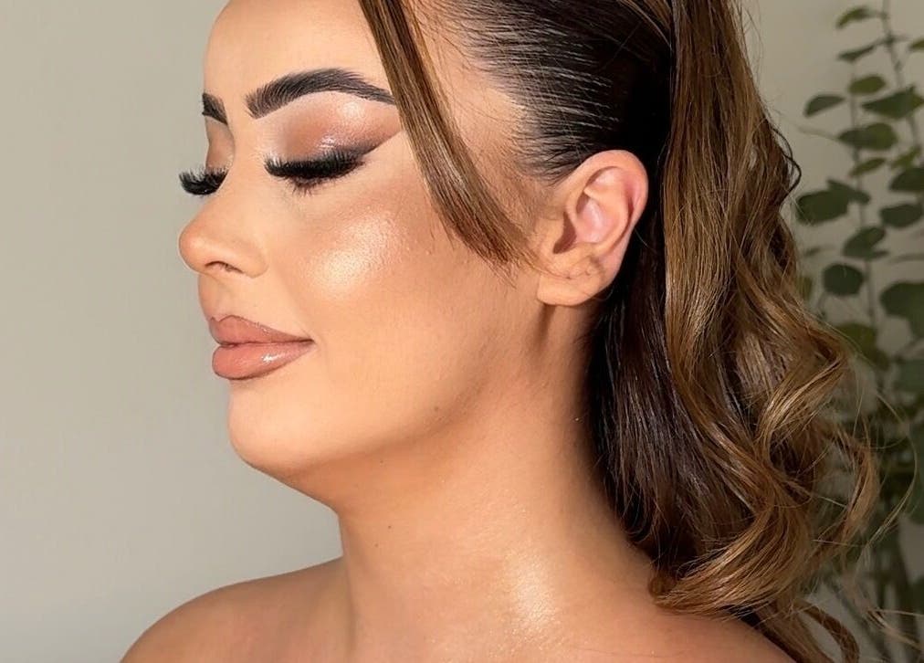 Elegant makeup look by Aria Beauty in Enfield, England, GB features glossy lips and shimmering skin.