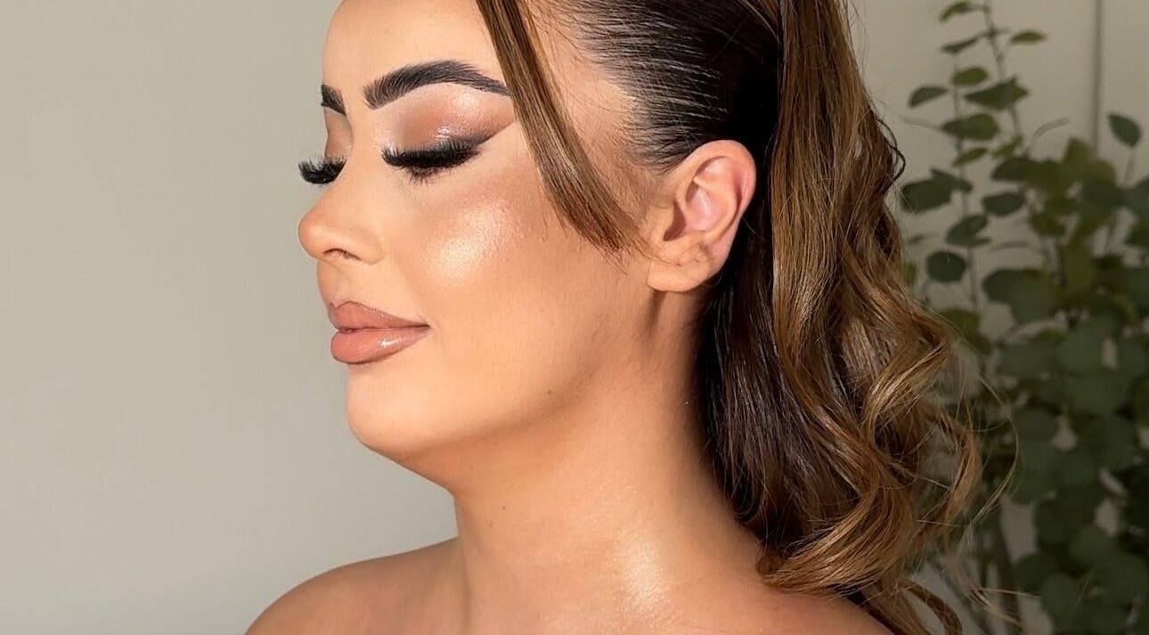 Elegant makeup look by Aria Beauty in Enfield, England, GB features glossy lips and shimmering skin.