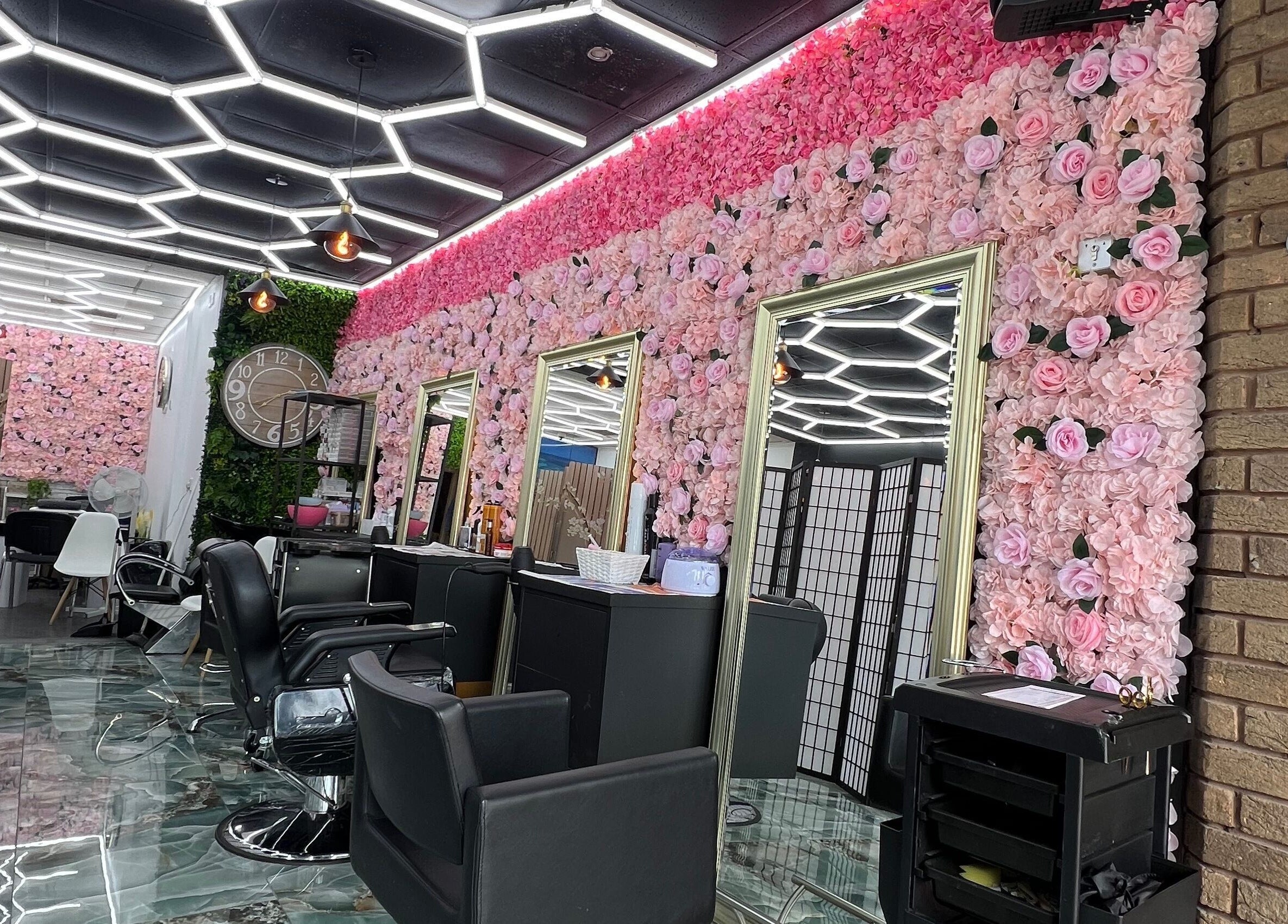Luxurious interior of Lady’s Lux Beauty in Salford, England, GB with floral walls and chic seating.