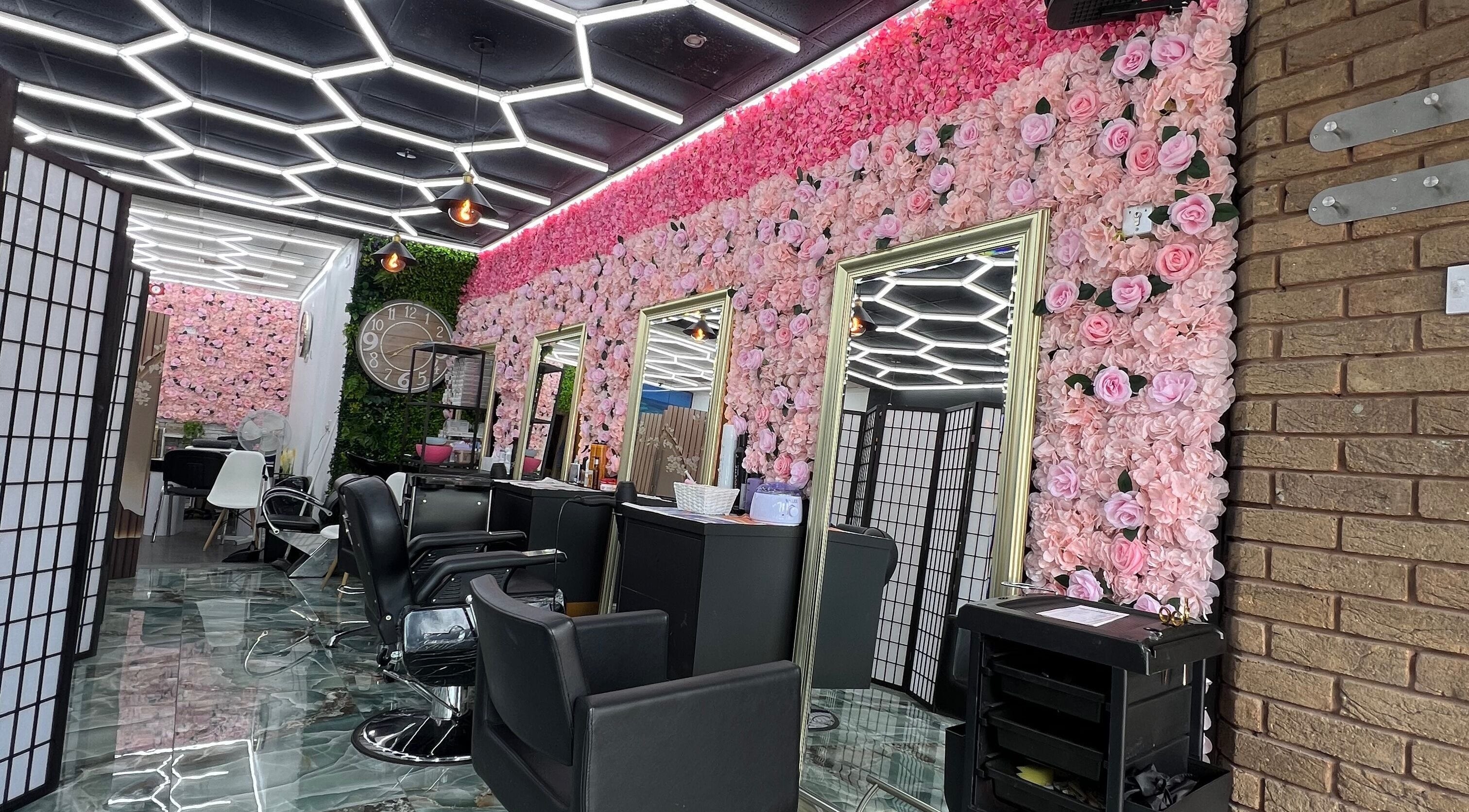 Luxurious interior of Lady’s Lux Beauty in Salford, England, GB with floral walls and chic seating.
