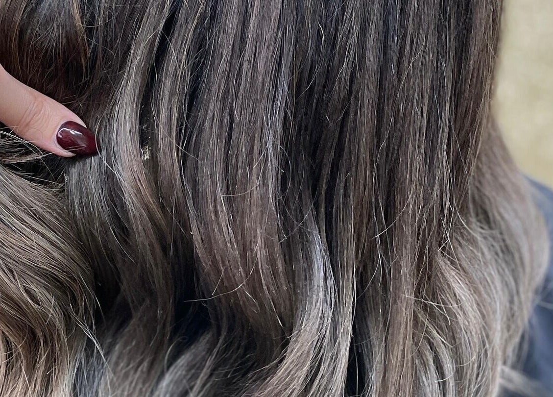 Close-up of shiny, styled hair highlighting expert care at Lady's Lux Beauty, Salford, England, GB.