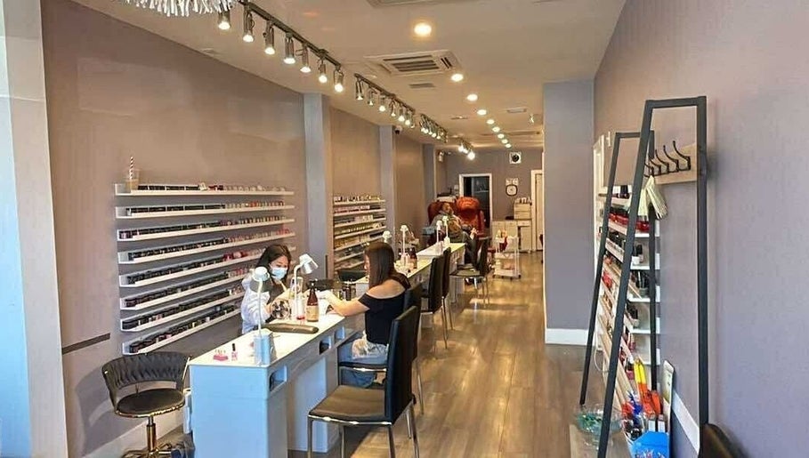 Interior of Westboro Infinity Nails in Ottawa, Ontario, CA, showcasing manicure stations and polish displays.
