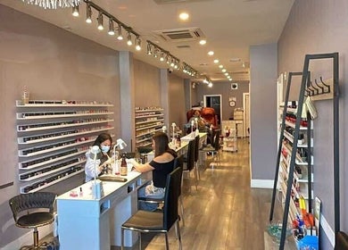Interior of Westboro Infinity Nails in Ottawa, Ontario, CA, showcasing manicure stations and polish displays.