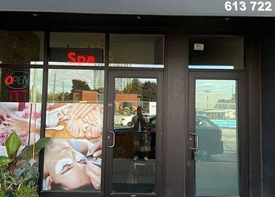 Exterior of Westboro Infinity Nails, Ottawa, Ontario, CA with spa signage and greenery.