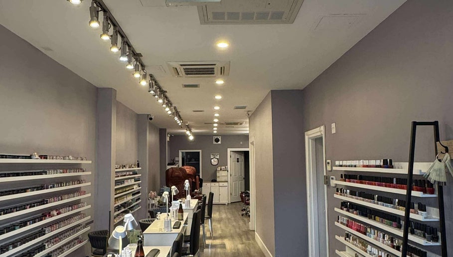 Interior of Westboro Infinity Nails in Ottawa, Ontario, CA, showcasing nail polish display and chic decor.