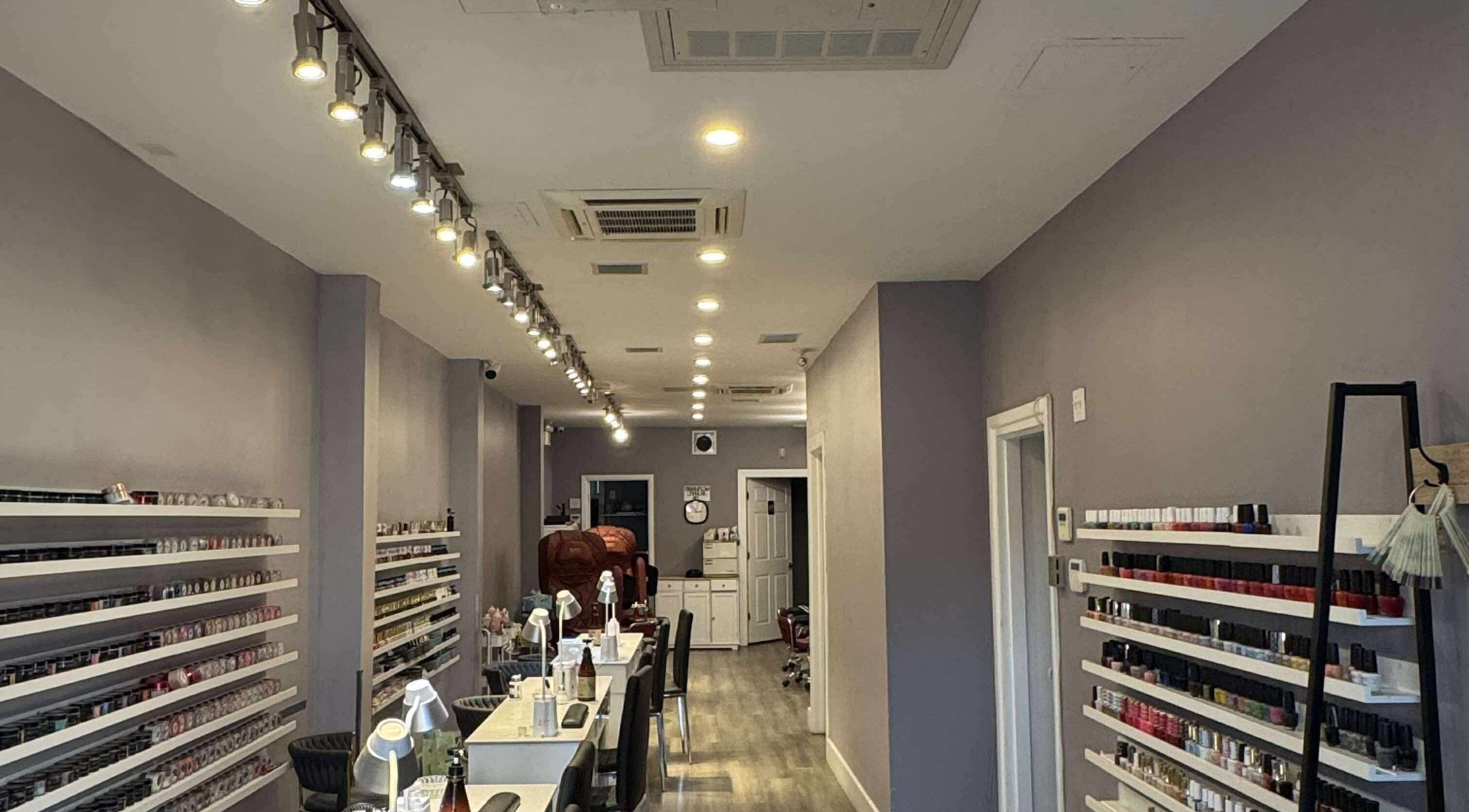 Interior of Westboro Infinity Nails in Ottawa, Ontario, CA, showcasing nail polish display and chic decor.