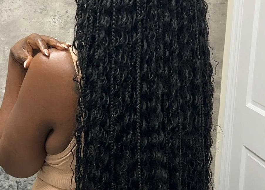 Long, curly hairstyle showcased at Skin Knead Beauty, Nassau, New Providence, BS.