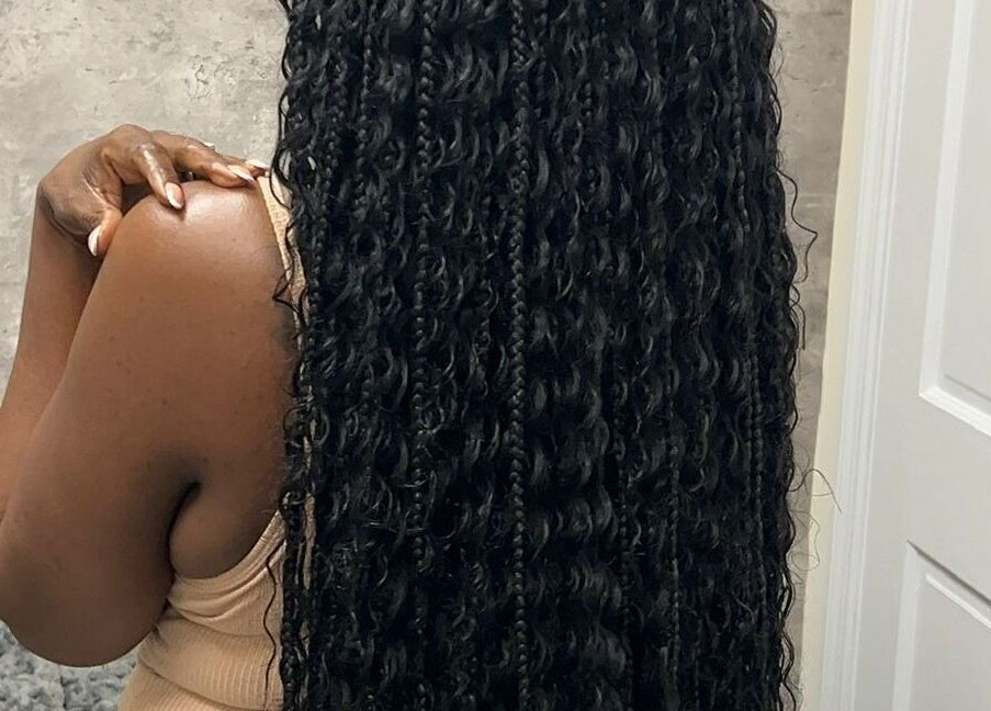 Long, curly hairstyle showcased at Skin Knead Beauty, Nassau, New Providence, BS.