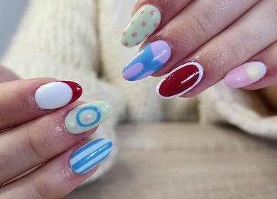 Vibrant nail art at Velvet Beauty Salon, Wellington, NZ showcasing intricate designs and bold colors.