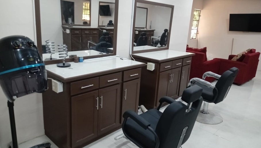 Chic interior at Mesha’s Hair Studio💗 in San Fernando, TT featuring modern styling chairs and mirrors.